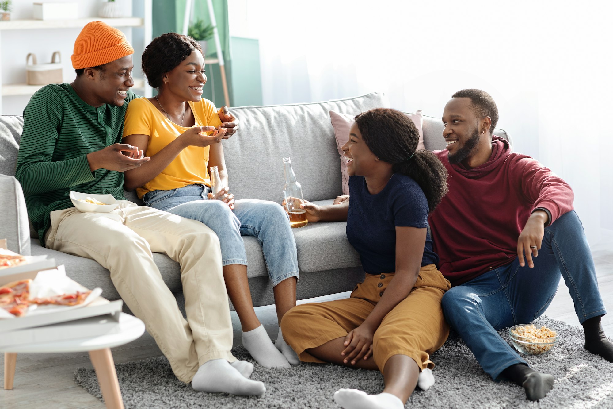 Cheerful african american men and women spending time at home